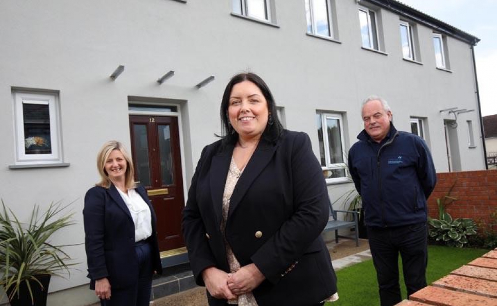 The Minister is pictured with (L) Grainia Long, CEO of the Housing Executive and (R) Gerry McEvoy of contractor M&M construction at Cliftondene Park in North Belfast
